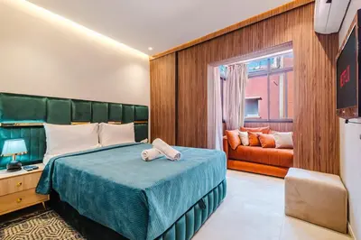 a bedroom with a bed and a couch at NEW 2Br Family-Friendly, in the Heart of Marrakech in Marrakech