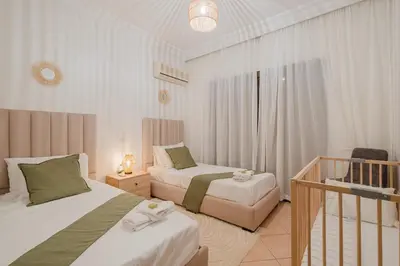 a hotel room with two beds and a balcony at NEW 2Br Family-Friendly, in Center of Marrakech in Marrakech