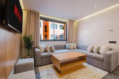 a living room with a couch and a table at NEW 1BR Apart Queensize AC 5 min to CityCenter in Marrakech