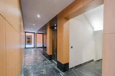 a hallway of a building with wooden walls and marble floors at NEW 1BR Apart Queensize AC 5 min to CityCenter in Marrakech