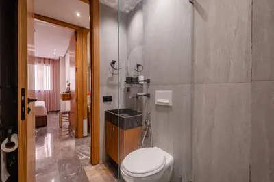 a bathroom with a toilet and a glass shower at New 2BR AC 5min from City Center-4 to 5Guests in Marrakech