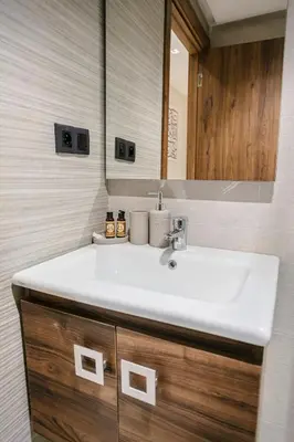 a bathroom with a white sink and a mirror at The Luxury Gate Duplex Private Pool in Marrakech