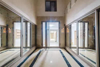 an empty room with glass doors and windows at NEW Apartment Central 1BR-Queensize, AC&Terrace in Marrakech