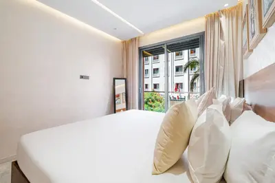 a bedroom with a white bed and a window at Modern Comfort in Heart of Marrakech in Marrakech
