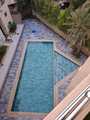 a swimming pool with blue water in a building at Burj malak in Marrakech