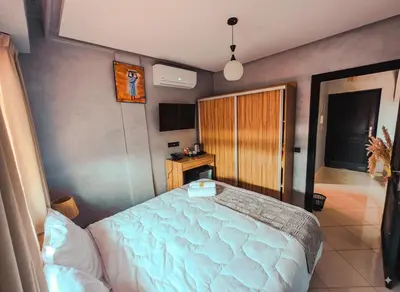 a bedroom with a large bed in a room at NARJI HOTEL Guéliz in Marrakech