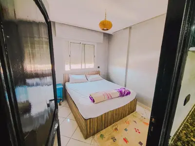 a small bedroom with a bed in a room at NARJI HOTEL Guéliz in Marrakech
