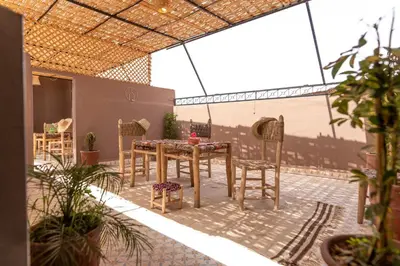 a patio with a table and chairs in a room at Cozy studio with private terrace in Marrakech