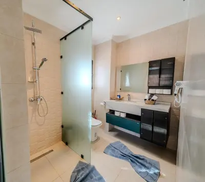 a bathroom with a shower and a sink and a toilet at Villa Smahane - Comfort & Private Pool in Marrakech