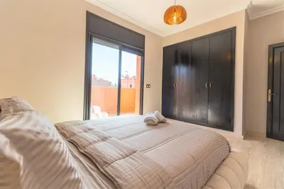 a bedroom with a bed with a stuffed animal on it at Luxury private villa with heated pool in Marrakech