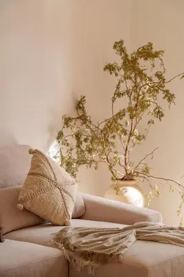 a living room with a couch and a plant at Le Lys - Prestigia Argan - Golf - 6 Prs - Piscine in Marrakech