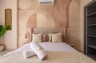 a bedroom with a bed with white towels on it at Le Lys - Prestigia Argan - Golf - 6 Prs - Piscine in Marrakech
