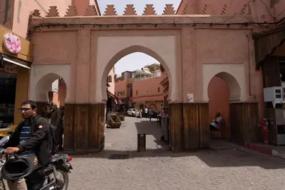 a man sitting on a motorcycle in front of a building at Apartment with panoramic views of Koutoubia in Marrakech