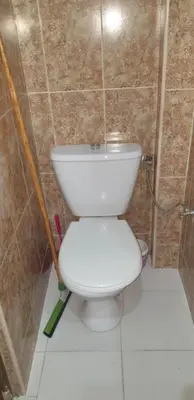 a bathroom with a toilet in a tiled wall at Chez Omar in Marrakech