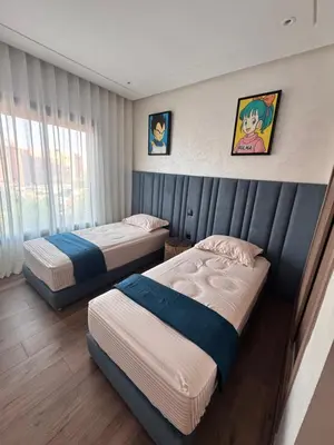 two beds in a hotel room with two beds sidx sidx sidx at Le pavillon gueliz appartement de luxe in Marrakech
