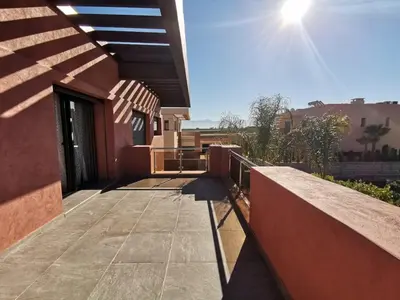 a balcony of a house with the sun in the sky at Magnifique villa spacieuse Route de l'ourika in El Rhechat