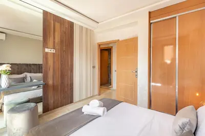 a bedroom with a bed and a large mirror at Elegant 2BR Modern Prime District in Marrakech in Marrakech
