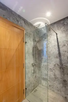 a bathroom with a shower with a glass door at Elegant 2BR Modern Prime District in Marrakech in Marrakech