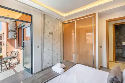 a bedroom with a bed with towels on it at Elegant 2BR Modern Prime District in Marrakech in Marrakech