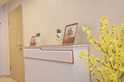 a shelf with three pictures and a plant in a room at Appartement à Marrakech Terrasse et piscine in Marrakech