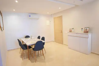 a kitchen and dining room with a table and chairs at Appartement à Marrakech Terrasse et piscine in Marrakech