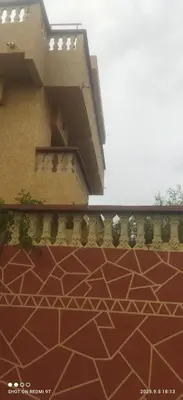 a balcony of a building with a brick floor at Jolie petite villa in Marrakech