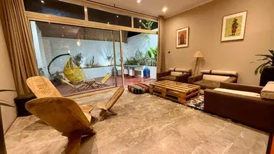 a living room with a large window and a couch at Du coté de chez Ikram in Marrakech
