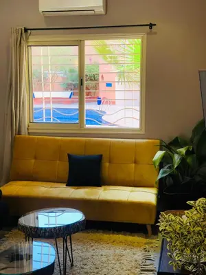 a living room with a couch and a window at Du coté de chez Ikram in Marrakech