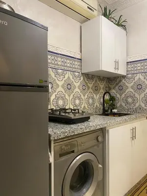 a kitchen with a washing machine in a kitchen at chez Zaki in Marrakech