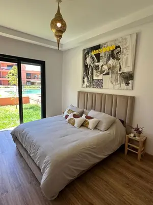 a bedroom with a large bed with posters on the wall at ART NORIA Private garden - pool view in Marrakech