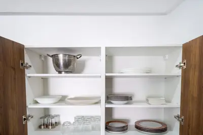 a cupboard with plates and dishes in it at Studio prestige in Marrakech