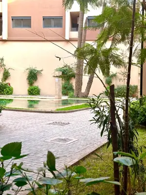 a pool of water in front of a building at Studio prestige in Marrakech