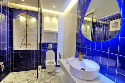 a blue tiled bathroom with a sink and a toilet at Luxury Apartment Retreat in Marrakech in Marrakech
