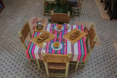 a table with a plate of food on it at Riad Eljazouli in Marrakech