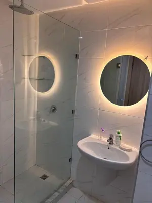 a bathroom with a sink and a glass shower at Your Host in Marrakech