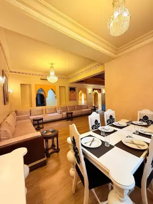 a dining room with a table and a couch at VILLA 33 - 4 Master Suites, Stylish Moroccan Design & Private Pool in Marrakech