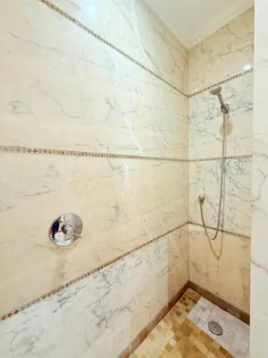 a bathroom with a shower with marble walls at VILLA 33 - 4 Master Suites, Stylish Moroccan Design & Private Pool in Marrakech