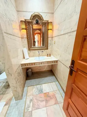 a bathroom with a sink and a mirror at VILLA 33 - 4 Master Suites, Stylish Moroccan Design & Private Pool in Marrakech