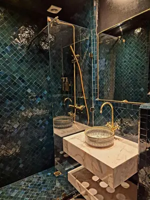 a bathroom with two sinks and a glass shower at Riad Beltza - 