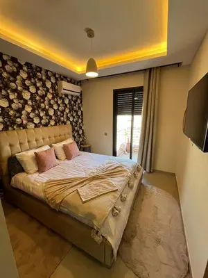 a bedroom with a bed and a wall with logs at Appart Chic and Cosy, proche Gueliz in Marrakech