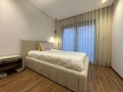 a bedroom with a bed and a large window at Elegant 2BDR Apartment with Pool in Gueliz in Marrakech