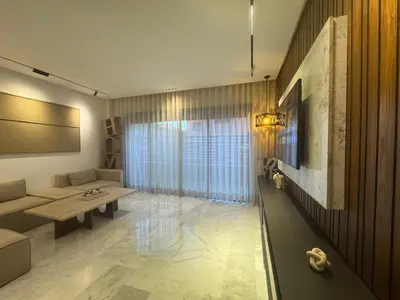 a living room with a couch and a table at Elegant 2BDR Apartment with Pool in Gueliz in Marrakech