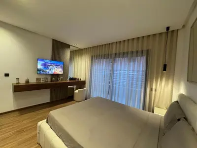 a hotel room with a bed and a television at Elegant 2BDR Apartment with Pool in Gueliz in Marrakech