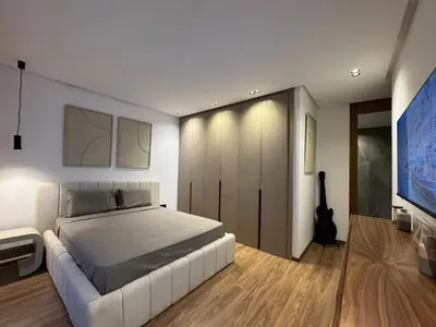 a bedroom with a large white bed and a guitar at Elegant 2BDR Apartment with Pool in Gueliz in Marrakech