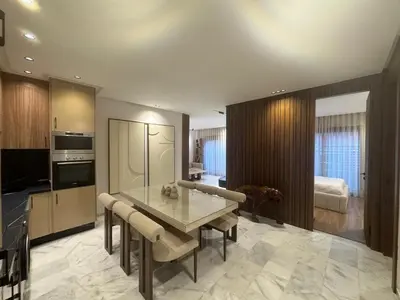 a kitchen and living room with a table and chairs at Elegant 2BDR Apartment with Pool in Gueliz in Marrakech