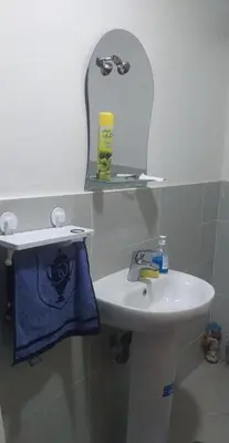a bathroom with a sink and a mirror at Residence Jnane Tissir Marrakech in Marrakech