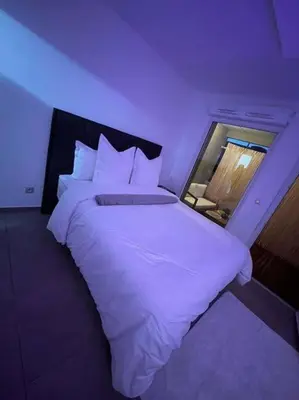 a bedroom with a large bed with white sheets at Dar lhssn in Marrakech