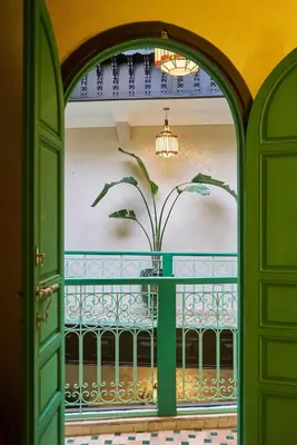 an open door with a plant on a balcony at Riad Lia ou Lik in Marrakech