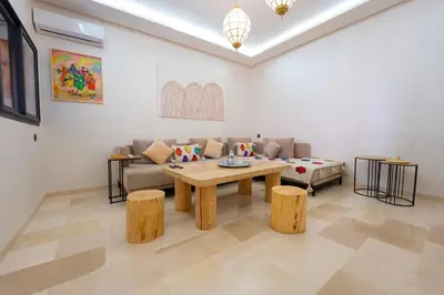 a living room with a couch and a table at Gueliz Central Apartment with Pool and Parking in Marrakech
