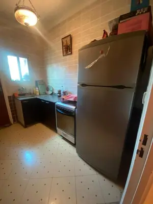 a kitchen with a stainless steel refrigerator and a counter at Marrakech house Your Haven of Peace in Marrakech in Marrakech